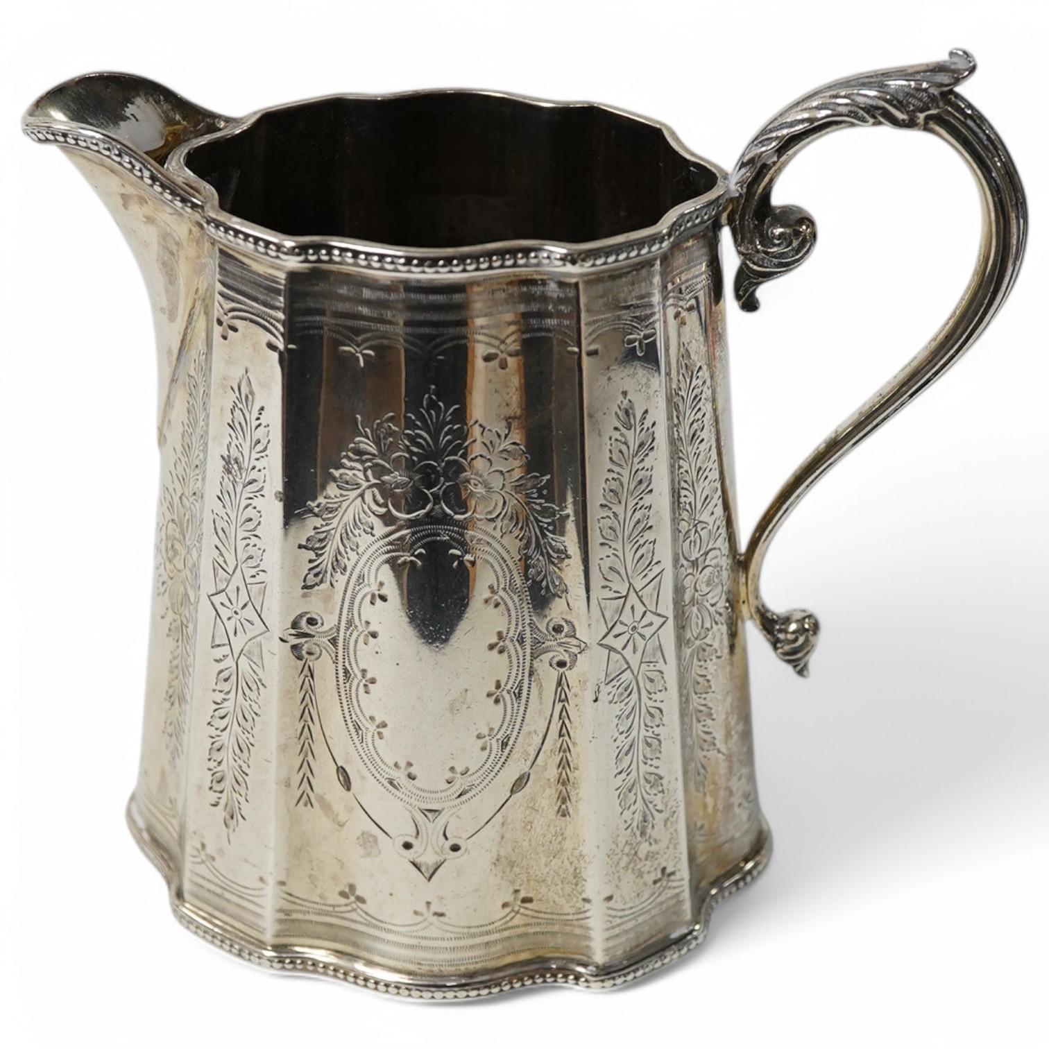 A late Victorian engraved silver cream jug, with beaded borders, by Barker Brothers, Birmingham, 1897, height 12.7cm, 8.4oz. Condition - fair to good